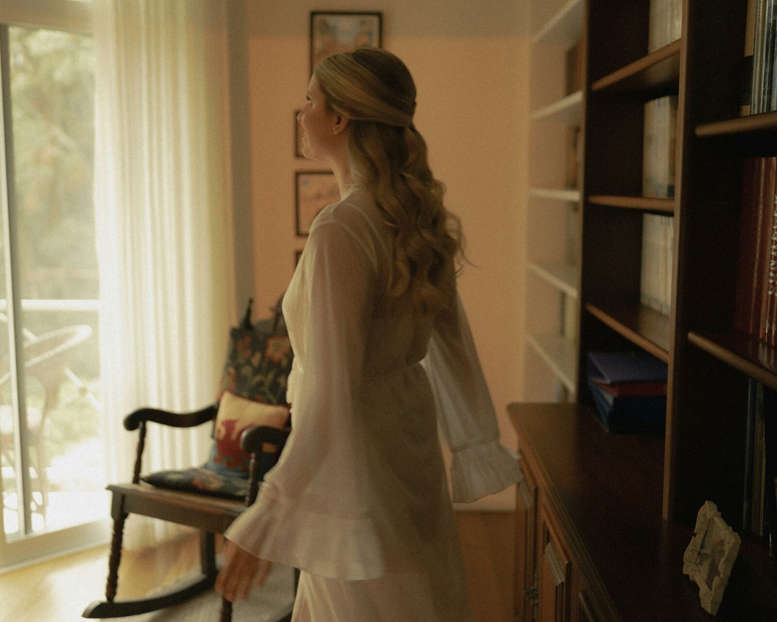 A woman moving quietly through a warm family home