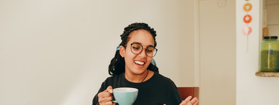 A woman laughing over a warm drink during a check in