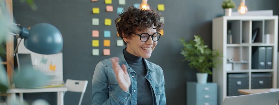 A woman waving hello at the start of a video call